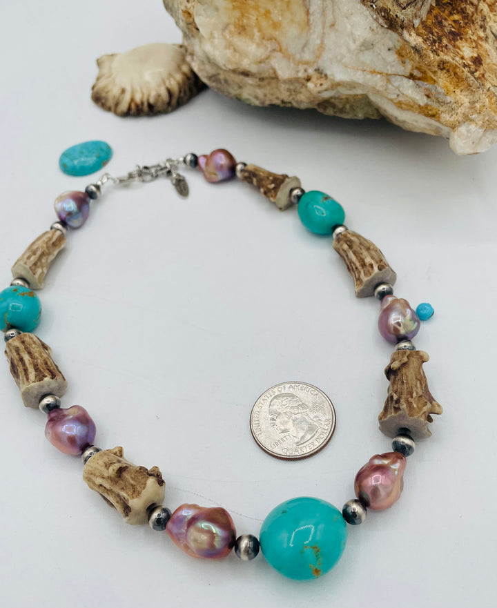 Beaded necklace featuring Kingman turquoise nuggets, baroque natural luster pearls, textured deer antler, and sterling silver beads. U.S. quarter for size reference. Available only from Rockstar Cowgirl online or in store in Cody, Wyoming.