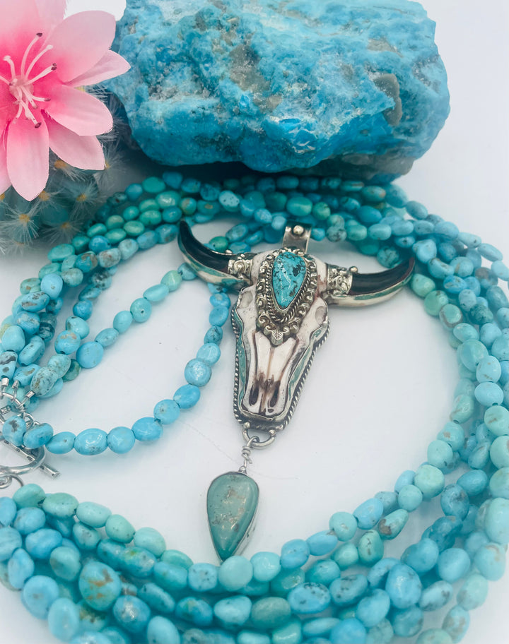 7 stranded beaded necklace featuring Sonoran turquoise nuggets, and a hand carved steer pendent with turquoise details. Available only from Rockstar Cowgirl online or in store in Cody, Wyoming.