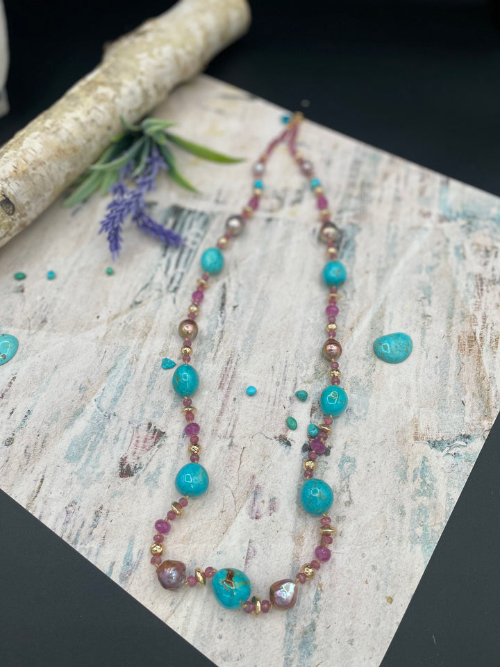 Silk knotted necklace featuring natural luster Edison pearls, rubies, Kingman turquoise nuggets, and hammered 14k beads, Available only from Rockstar Cowgirl online or in store in Cody, Wyoming.