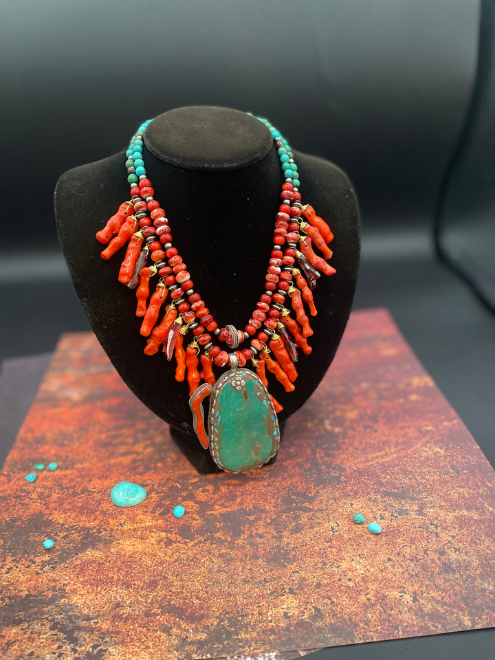 A double strand necklace featuring red spiny oyster, sponge coral, Tibetan turquoise, Swarovski coral crystal spikes, sterling silver beads, with a turquoise and coral pendent. Available only from Rockstar Cowgirl online or in store in Cody, Wyoming.