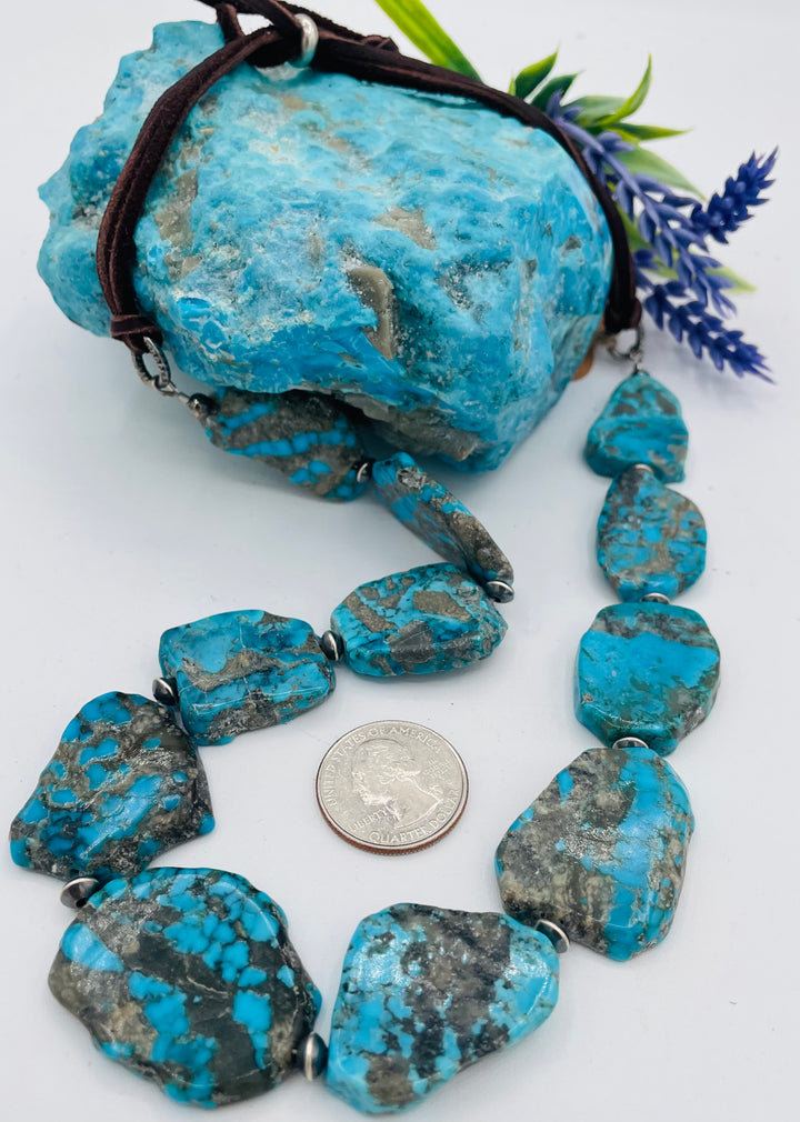 Adjustable beaded hatband that doubles as a necklace featuring Ithaca Peak turquoise and sterling silver beads finished with deer lace in  the back. U.S. quarter for size reference. Available only from Rockstar Cowgirl online or in store in Cody, Wyoming.