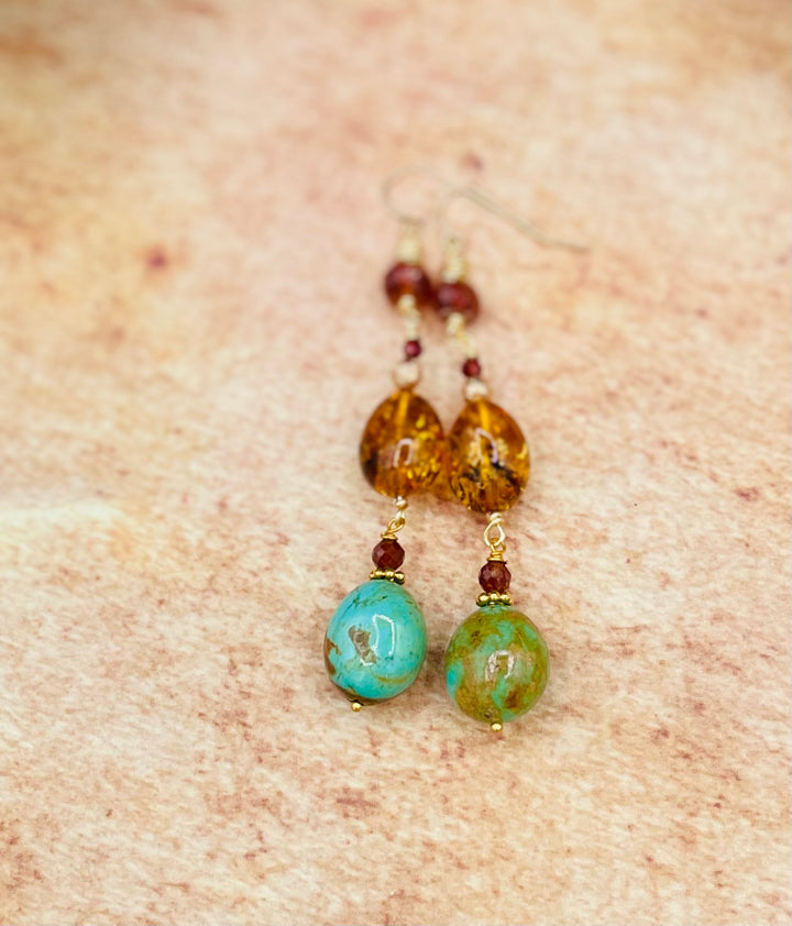 A close up of the Kingman turquoise, Baltic amber, and garnet earrings. Available only from Rockstar Cowgirl online or in store in Cody, Wyoming.