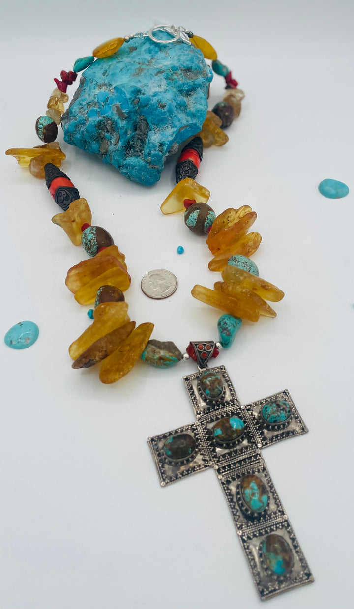 Beaded necklace featuring #8 turquoise, yellow Baltic amber, coral, sterling silver beads, silver and coral tube beads, and a sterling silver cross with #8 turquoise nuggets. Available only from Rockstar Cowgirl online or in store in Cody, Wyoming.