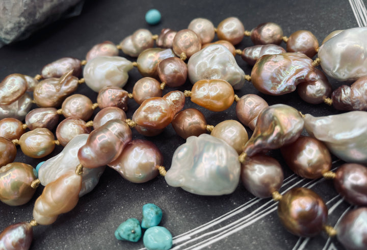 Close up of the natural luster, colors, and shapes of this silk knotted 3 strand baroque pearl necklace set.