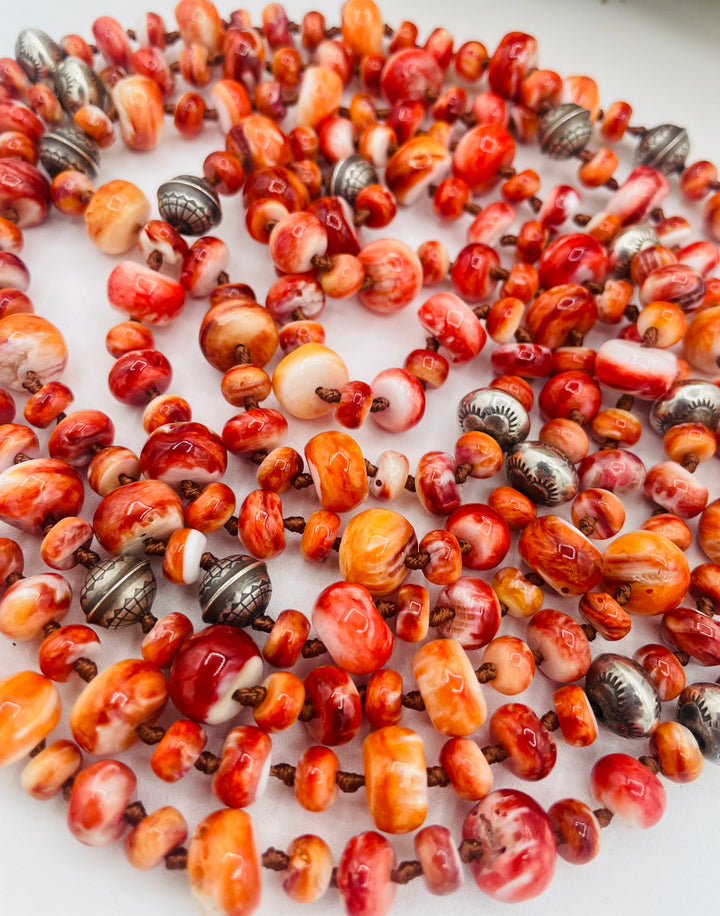 Silk knotted lariat necklace featuring spiney oyster, sterling silver stamped beads, and vintage sterling silver western charms. Available only from Rockstar Cowgirl online or in store in Cody, Wyoming.