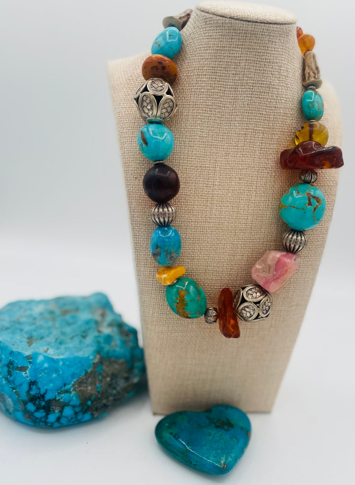 Chunky beaded necklace featuring Kingman turquoise, Ithaca Peak turquoise, textured deer antler, Baltic amber, pink opal, and sterling silver beads. Available only from Rockstar Cowgirl online or in store in Cody, Wyoming.