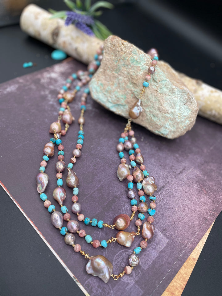 Silk knotted and wire wrapped treasure necklace set featuring baroque natural luster pearls, rhodochrosite, and turquoise beads. Includes matching earrings. Available only from Rockstar Cowgirl online or in store in Cody, Wyoming.