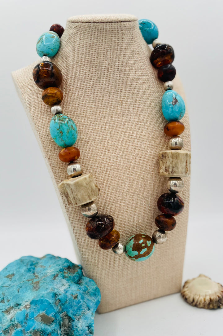 Chunky beaded necklace featuring Baltic amber, textured deer antler, sterling silver beads, and Kingman turquoise nuggets. Available only from Rockstar Cowgirl online or in store in Cody, Wyoming.