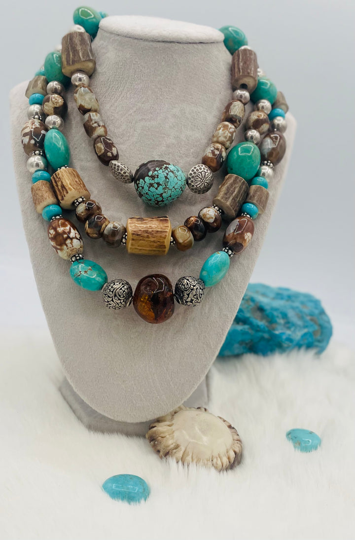 Beaded 3 strand necklace featuring #8 turquoise nuggets, Kingman turquoise nuggets, royal beauty turquoise, crazy lace agate, textured deer antler, and sterling silver beads. Available only from Rockstar Cowgirl online or in store in Cody, Wyoming.