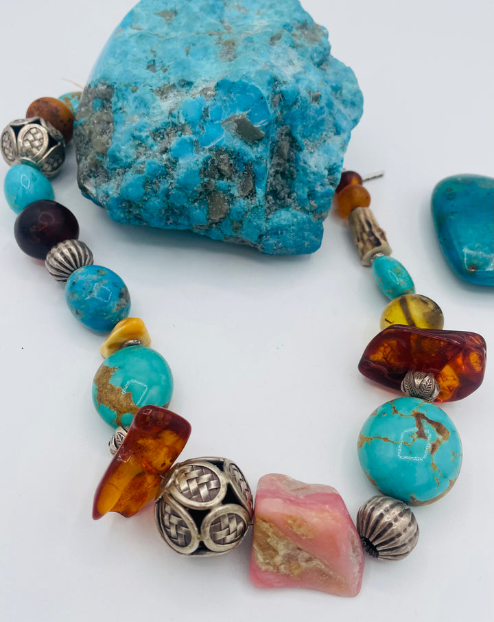 Chunky beaded necklace featuring Kingman turquoise, Ithaca Peak turquoise, textured deer antler, Baltic amber, pink opal, and sterling silver beads. Available only from Rockstar Cowgirl online or in store in Cody, Wyoming.