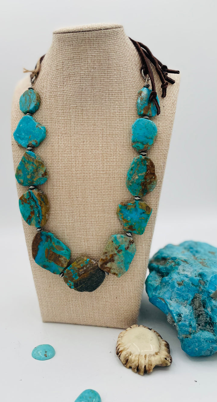 Adjustable beaded hatband that double as a necklace featuring Kingman turquoise flats and sterling silver beads finished with deer lace in the back. Available only from Rockstar Cowgirl online or in store in Cody, Wyoming.