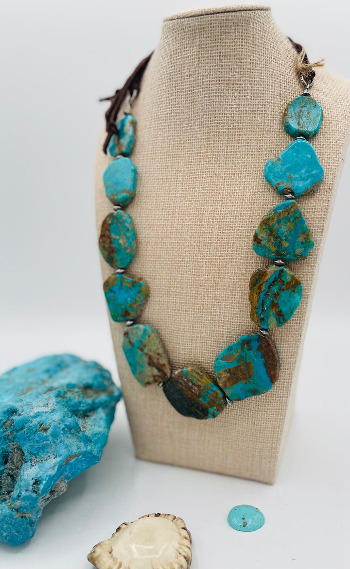 Adjustable beaded hatband that double as a necklace featuring Kingman turquoise flats and sterling silver beads finished with deer lace in the back. Available only from Rockstar Cowgirl online or in store in Cody, Wyoming.