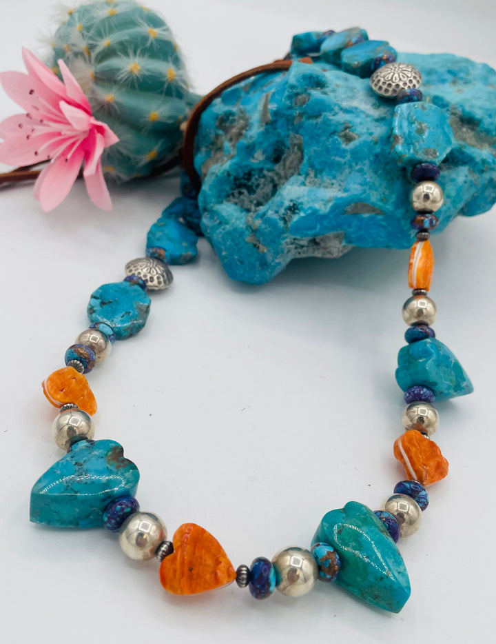 Adjustable beaded hatband featuring Kingman turquoise, purple Mojave turquoise, spiney oyster and turquoise hearts, sterling silver beads, and finished with deer lace in the back. Available only from Rockstar Cowgirl online or in store in Cody, Wyoming.