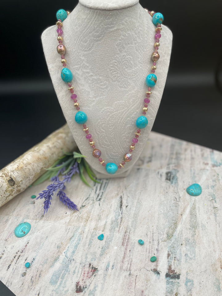 Silk knotted necklace featuring rubies, natural luster Edison pearls,  Kingman turquoise nuggets, and hammered 14k filled beads. Available only from Rockstar Cowgirl online or in store in Cody, Wyoming.
