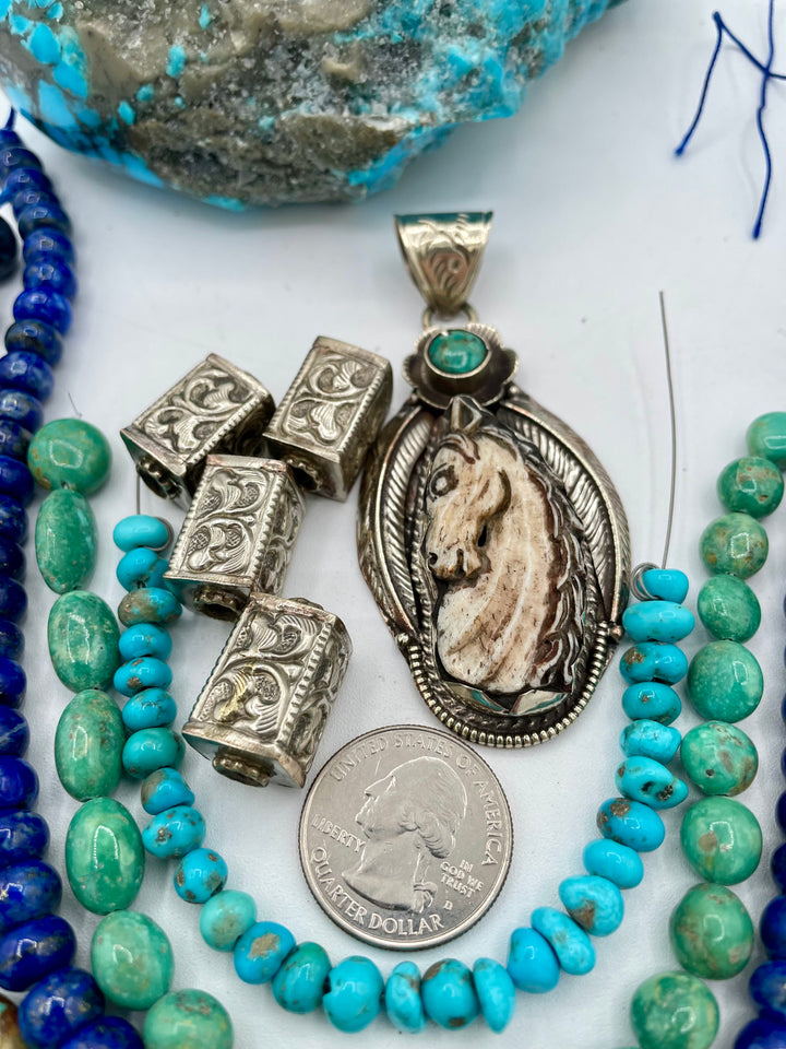 Bead box featuring strands of Kingman turquoise in blue and green, sodalite, denim lapis, Campitios turquoise, repousse beads, and hand carved bone horse pendent in Bali silver. U.S. quarter for size reference. One of a kind box available only from 
Rockstar Cowgirl online or in store in Cody, Wyoming.