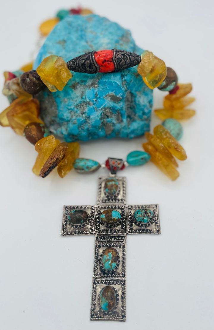 Beaded necklace featuring #8 turquoise, yellow Baltic amber, coral, sterling silver beads, silver and coral tube beads, and a sterling silver cross with #8 turquoise nuggets. Available only from Rockstar Cowgirl online or in store in Cody, Wyoming.