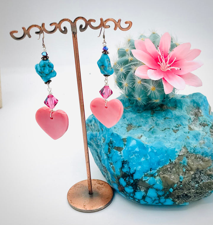 Handmade earrings featuring pink conch hearts, Swarovski crystals, and vintage Kingman turquoise. Available only from Rockstar Cowgirl online or in store in Cody, Wyoming.