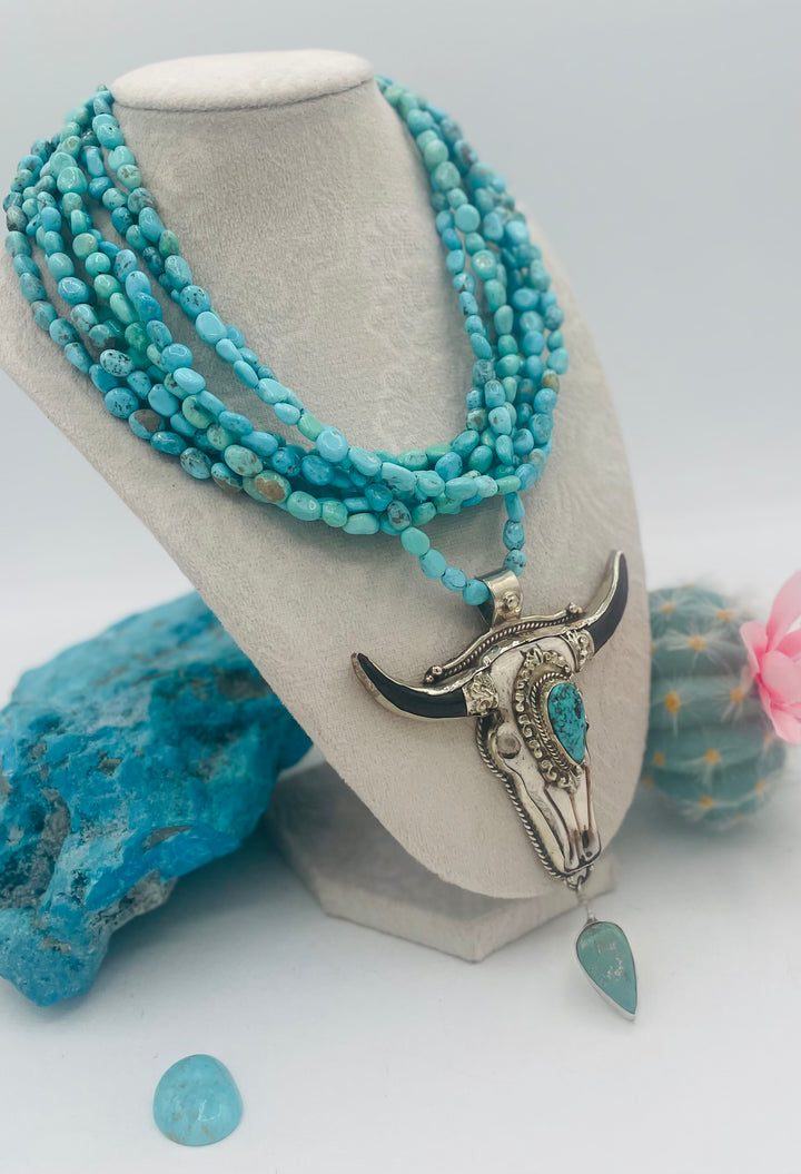 7 stranded beaded necklace featuring Sonoran turquoise nuggets, and a hand carved steer pendent with turquoise details. Available only from Rockstar Cowgirl online or in store in Cody, Wyoming.