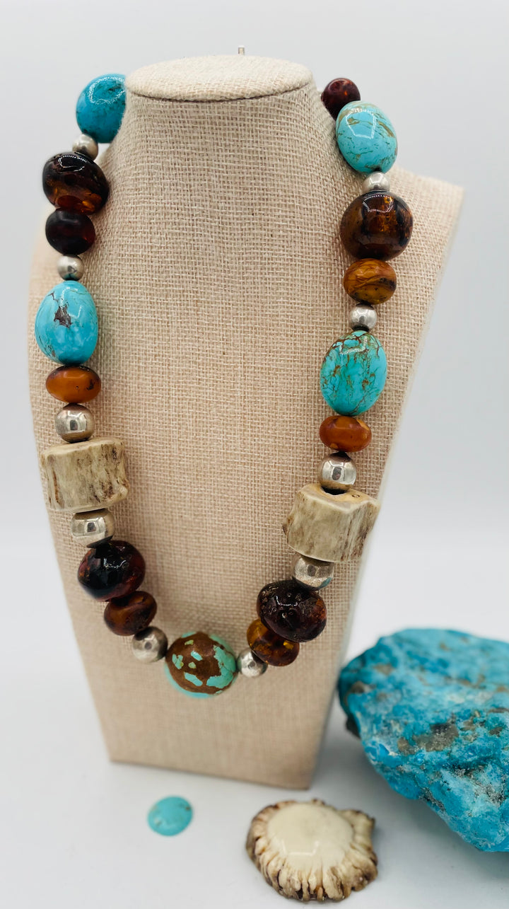 Chunky beaded necklace featuring Baltic amber, textured deer antler, sterling silver beads, and Kingman turquoise nuggets. Available only from Rockstar Cowgirl online or in store in Cody, Wyoming.