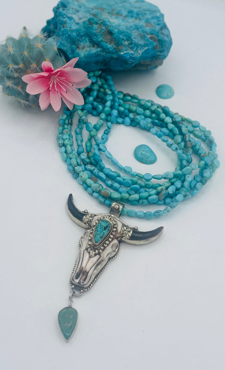 7 stranded beaded necklace featuring Sonoran turquoise nuggets, and a hand carved steer pendent with turquoise details. Available only from Rockstar Cowgirl online or in store in Cody, Wyoming.