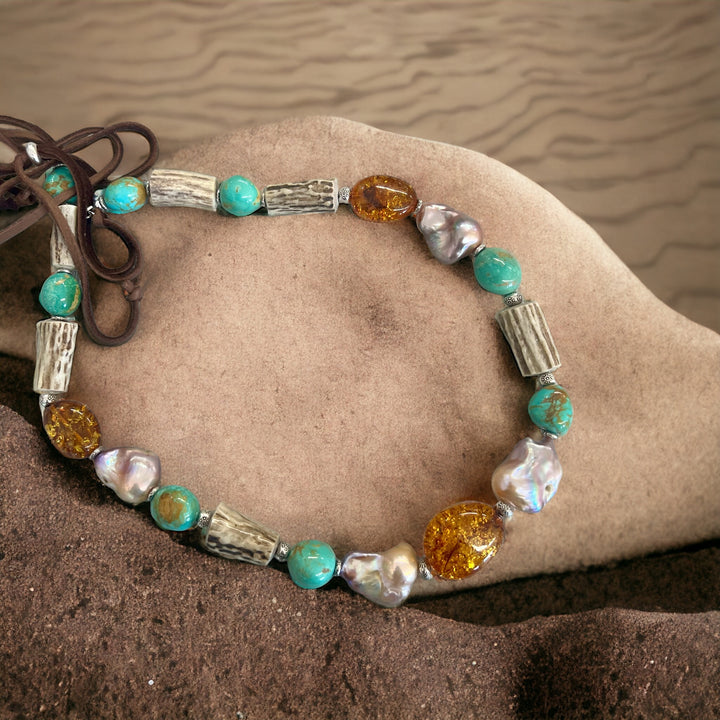 Hatband featuring Baltic amber, large baroque natural luster pearls, deer antler, and sterling silver beads finished with deer lace and a slide bead. Available only from Rockstar Cowgirl online or in store in Cody, Wyoming