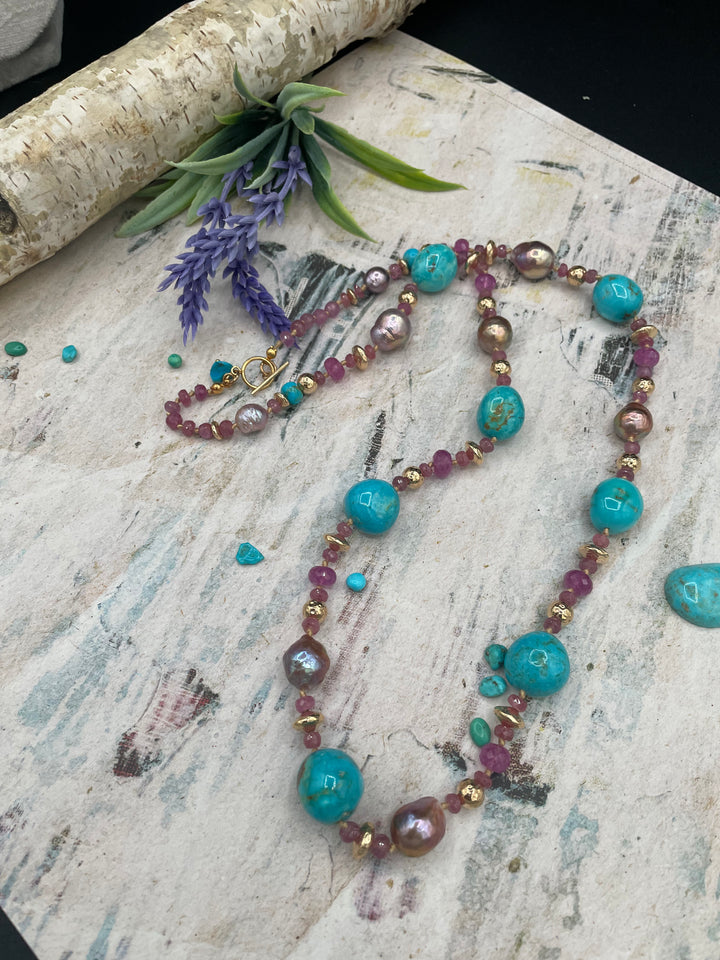Silk knotted necklace featuring natural luster Edison pearls, rubies, Kingman turquoise, and hammered 14k beads. Available only from Rockstar Cowgirl online or in store in Cody, Wyoming
