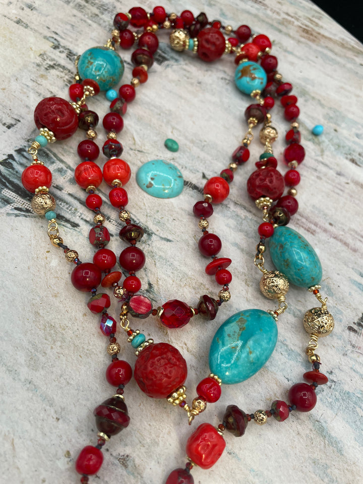 Close up of the matrix in the Kingman turquoise, red coral, red travertine beads, vintage Japanese cherry beads, and gold lava beads in the silk knotted and wire wrapped treasure necklace. Available only from Rockstar Cowgirl online or in store in Cody, Wyoming.