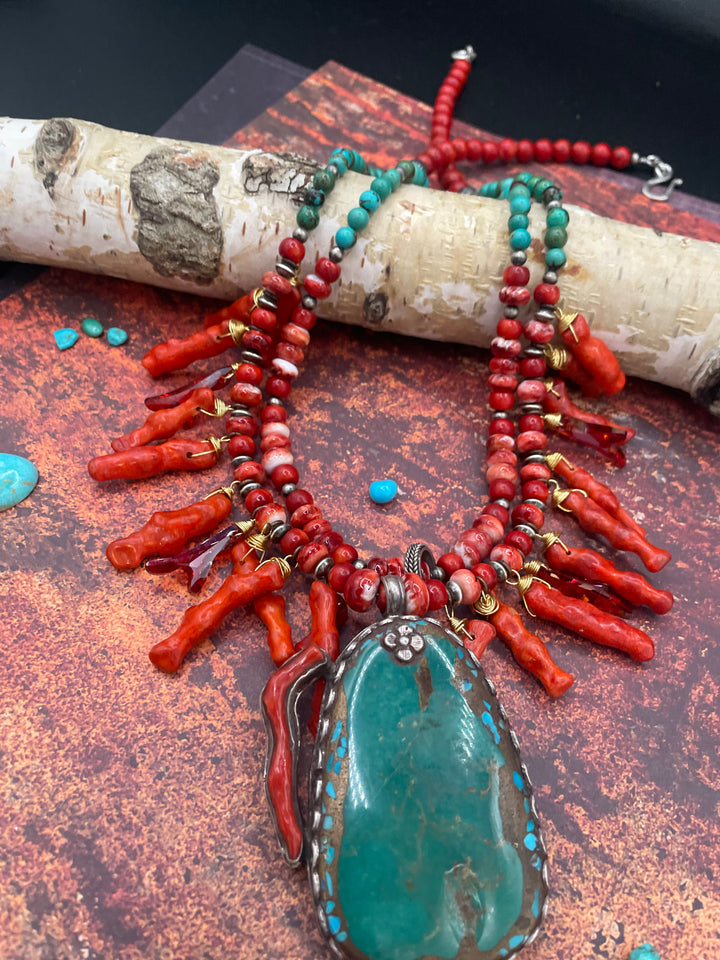 Close up featuring the red spiny oyster, sponge coral spikes, Swarovski crystal spikes, sterling silver beads, and turquoise and coral pendent. Available only from Rockstar Cowgirl online or in store in Cody, Wyoming.