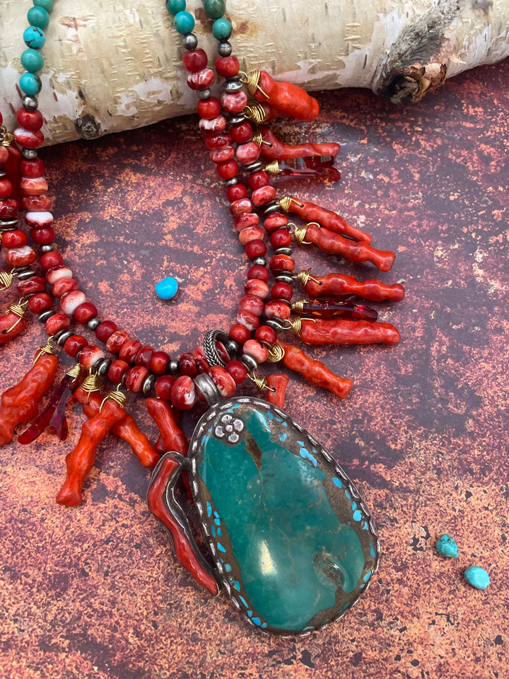 Close up featuring the red spiny oyster, sponge coral spikes, Swarovski crystal spikes, sterling silver beads, and turquoise and coral pendent. Available only from Rockstar Cowgirl online or in store in Cody, Wyoming.