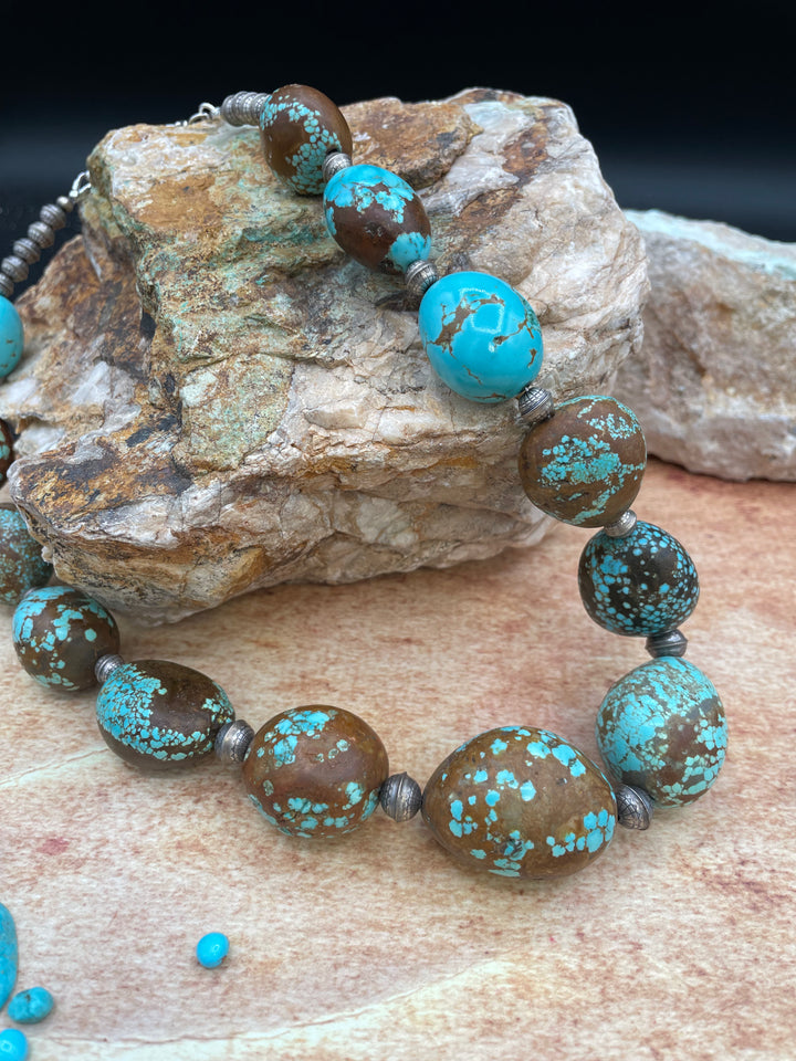 Close up of the matrix of the #8 turquoise and the texture of the etched sterling silver beads in this graduated necklace. Available only from Rockstar Cowgirl online or in store in Cody, Wyoming.