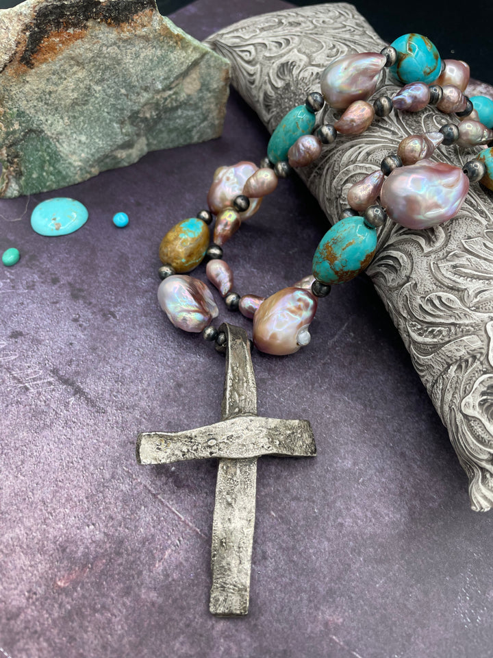 Close up of the handmade sterling silver cross pendent on the 2 strand necklace with baroque pearls, Kingman turquoise, and sterling silver beads. Available only from Rockstar Cowgirl online or in store in Cody, Wyoming.