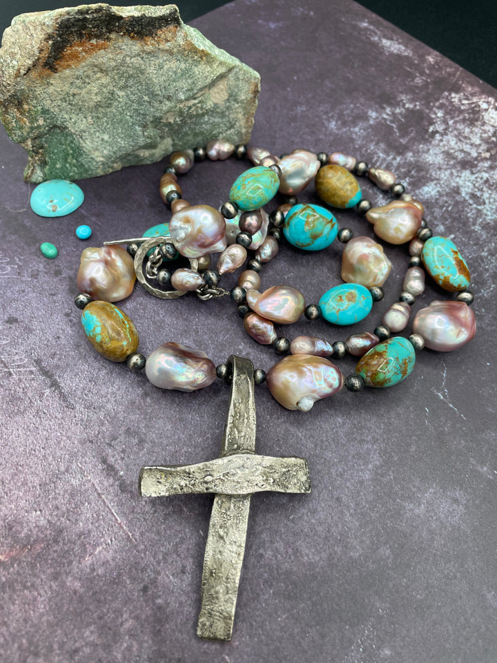 Close up of the matrix in the Kingman turquoise, colors of the natural luster baroque pearls, and the texture of the cross pendent on this 2 strand necklace. Available only from Rockstar Cowgirl online or in store in Cody, Wyoming.