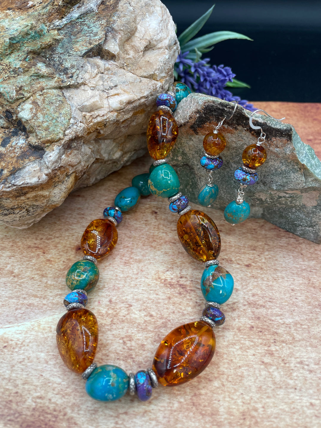 Large Baltic amber nuggets with blue Kingman and purple Mojave turquoise and sprinkled with Karen hill tribe sterling silver necklace. Including matching earrings.