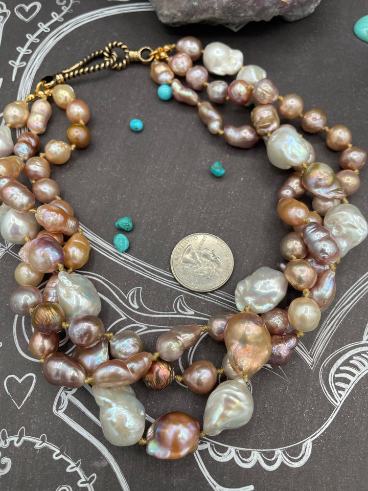 Silk knotted 3 strand baroque natural luster pearl twisted torsade or layered necklace and earring set. Featuring several shapes, sizes, and colored pearls all knotted on gold silk with a brass hook and eye clasp. U.S. quarter for size reference. Available only from Rockstar Cowgirl online or in store in Cody, Wyoming.