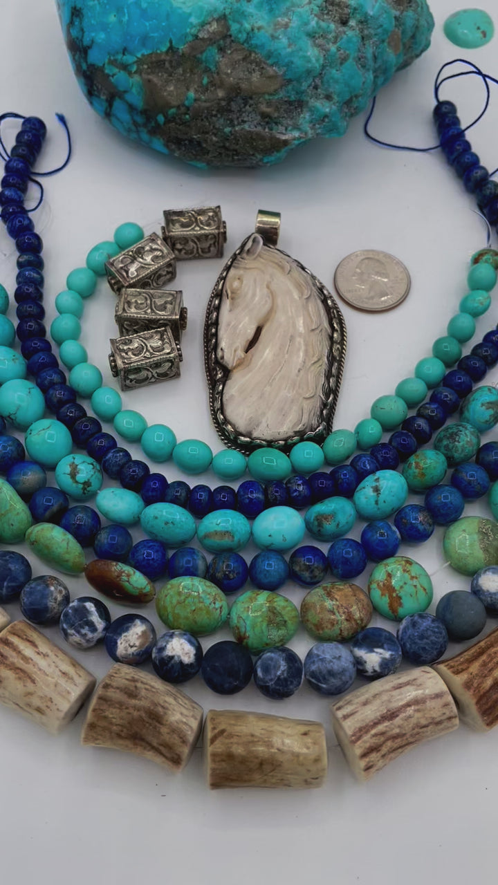 Bead box featuring strands of Kingman turquoise in blue and green, sodalite, denim lapis, Campitios turquoise, repousse beads, and hand carved bone horse pendent in Bali silver. U.S. quarter for size reference. One of a kind box available only from 
Rockstar Cowgirl online or in store in Cody, Wyoming.