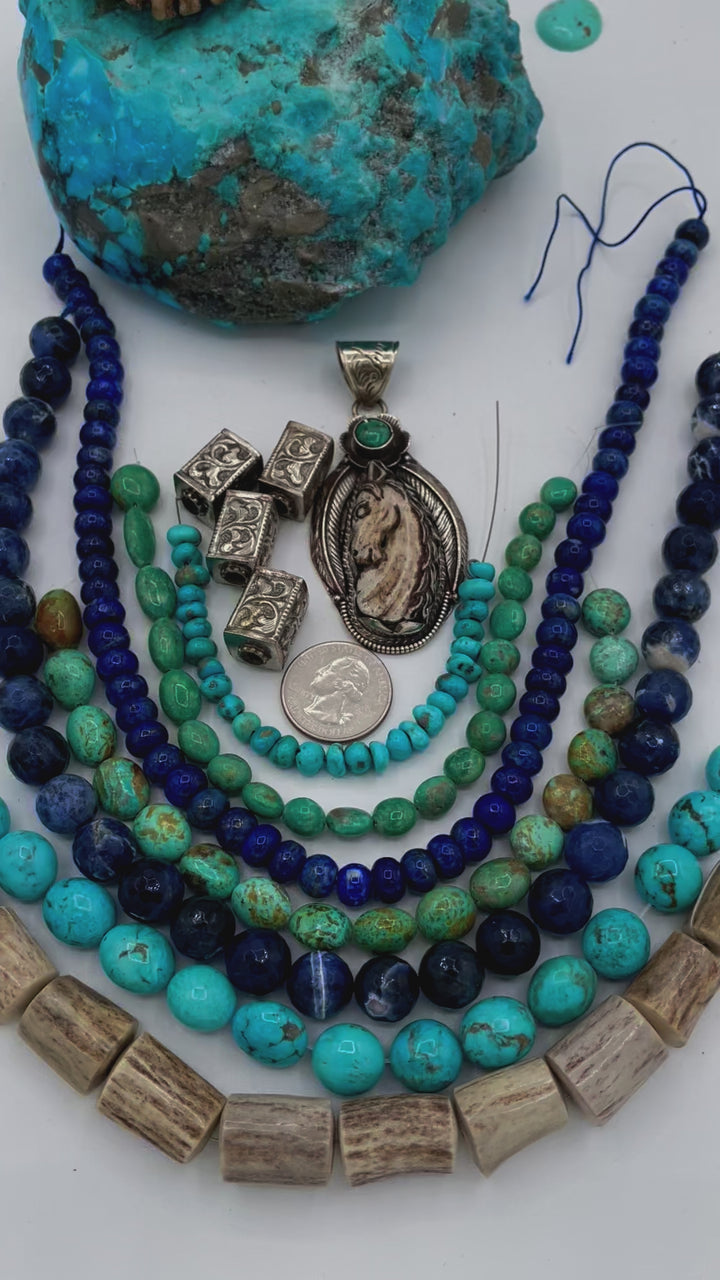 Bead box featuring strands of Kingman turquoise in blue and green, sodalite, denim lapis, Campitios turquoise, repousse beads, and hand carved bone horse pendent in Bali silver. U.S. quarter for size reference. One of a kind box available only from 
Rockstar Cowgirl online or in store in Cody, Wyoming.