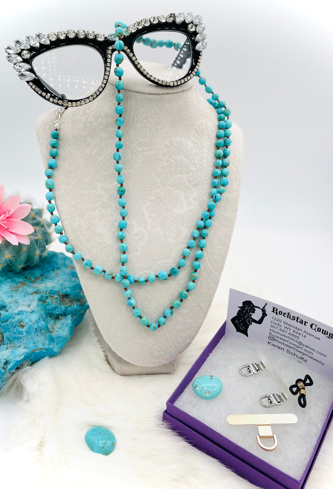 Silk knotted Kingman turquoise necklace, phone holder strap, or eyeglass holder featuring sterling silver swivel lobsters for various attachments or uses. Comes with phone case attachments and eye glasses loops. Available only from Rockstar Cowgirl online or in store in Cody, Wyoming.