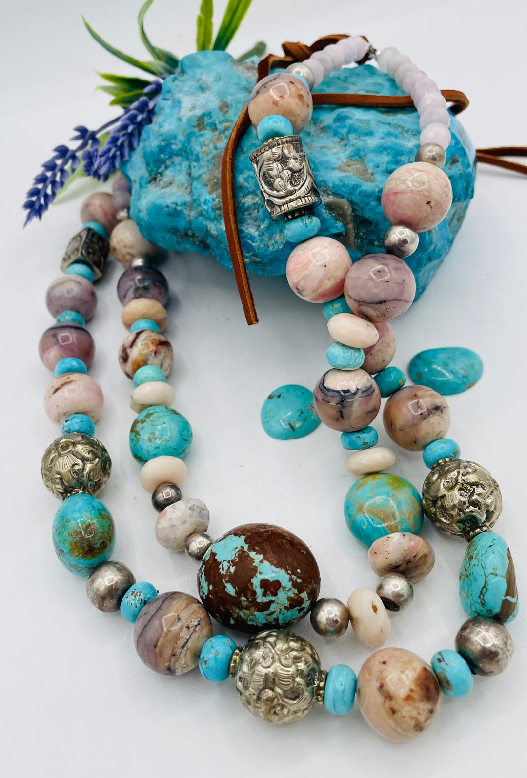 Adjustable beaded necklace featuring Pink opal, Royal beauty turquoise, Serling silver beads, Kingman turquoise, Repousse beads, pink morganite, number 8 turquoise nuggets, and finished with deer leather lace. Available only from Rockstar Cowgirl online or in store in Cody, Wyoming.