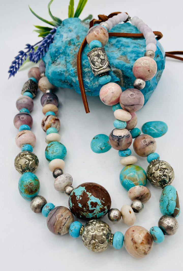 Adjustable beaded necklace featuring Pink opal, Royal beauty turquoise, Serling silver beads, Kingman turquoise, Repousse beads, pink morganite, number 8 turquoise nuggets, and finished with deer leather lace. Available only from Rockstar Cowgirl online or in store in Cody, Wyoming.