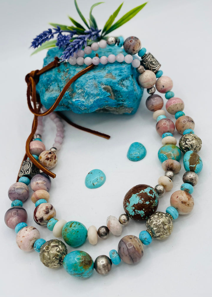 Adjustable beaded necklace featuring Pink opal, Royal beauty turquoise, Serling silver beads, Kingman turquoise, Repousse beads, pink morganite, number 8 turquoise nuggets, and finished with deer leather lace. Available only from Rockstar Cowgirl online or in store in Cody, Wyoming.