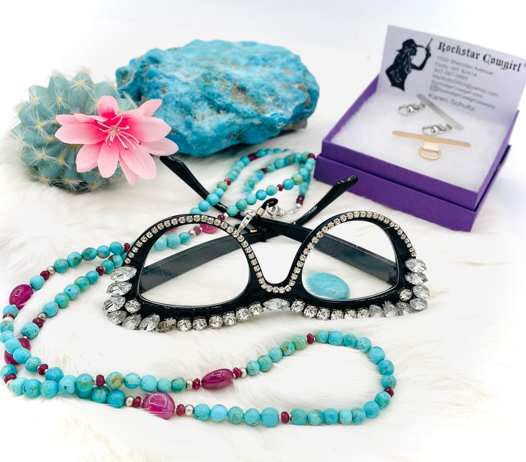 Beaded necklace, phone holder strap, or eye glass holder featuring blue Kingman turquoise, pink ruby nuggets and rondelles, sterling silver and African silver beads, sterling silver swivel lobsters, phone case attachments,  and glasses loops. Available only from Rockstar Cowgirl online or in store in Cody, Wyoming.