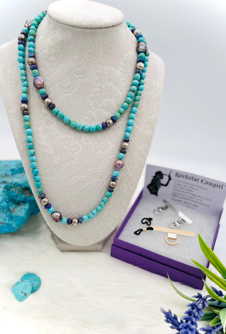 Beaded invention necklace featuring Kingman turquoise, Mojave Mohave turquoise, peacock pearls, sterling silver beads, and sterling silver swivel lobsters, with eye glasses loops and cell phone case attachment brackets. Available only from Rockstar Cowgirl online or in store in Cody, Wyoming.