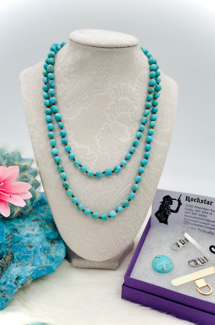 Silk knotted Kingman turquoise necklace, phone holder strap, or eyeglass holder featuring sterling silver swivel lobsters for various attachments or uses. Comes with phone case attachments and eye glasses loops. Available only from Rockstar Cowgirl online or in store in Cody, Wyoming.