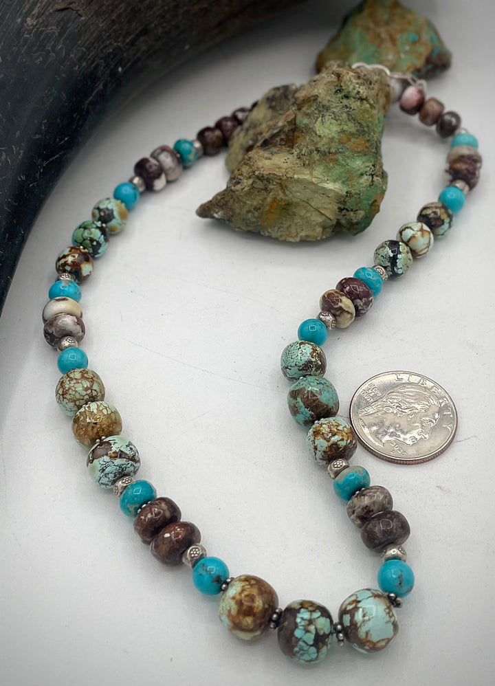 Handmade beaded necklace featuring natural cloud mountain Hubei turquoise, turquoise rounds, wild horse magnesite, and sterling silver beads. U.S. quarter for size reference. Available only from Rockstar Cowgirl online or in store in Cody, Wyoming.
