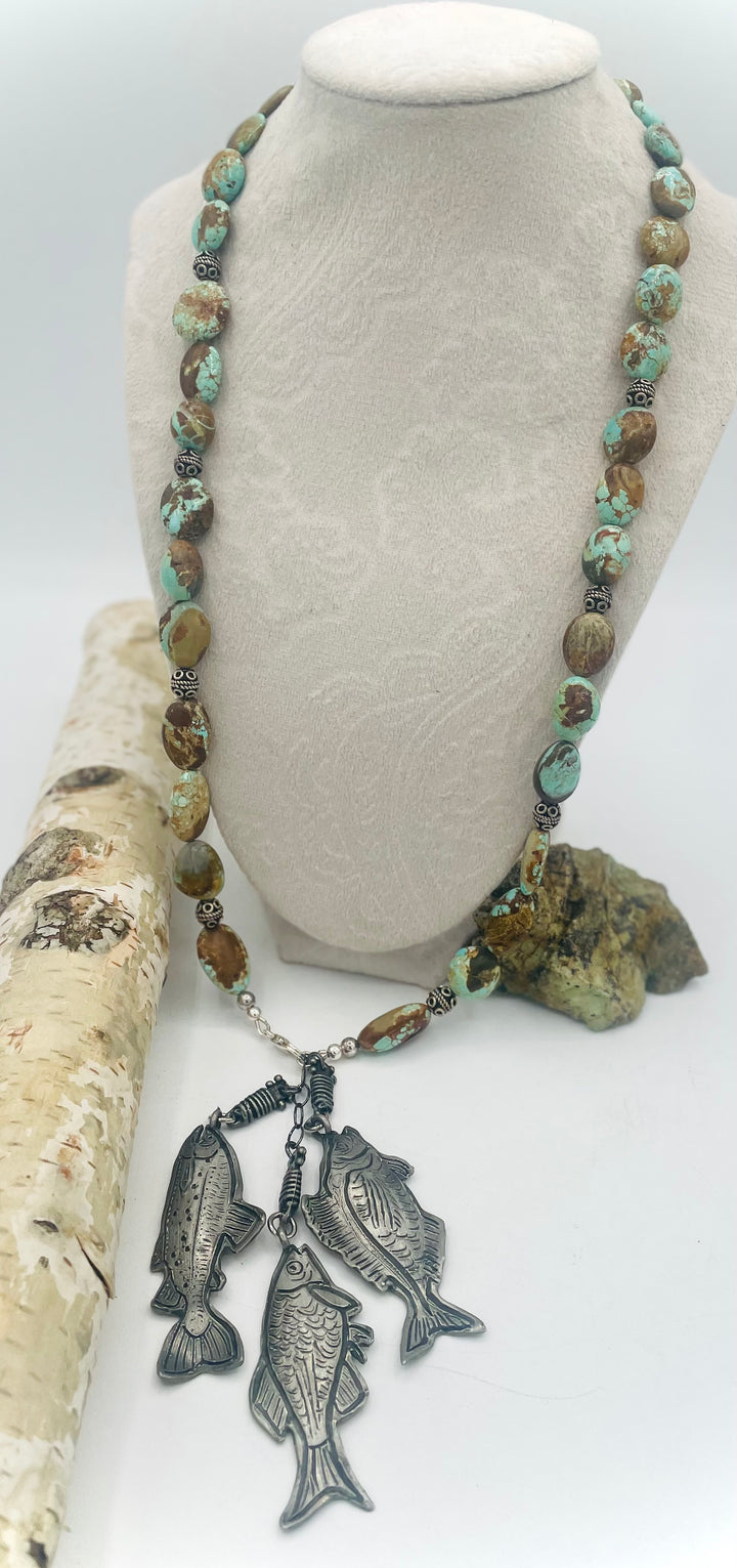 Beaded necklace featuring vintage #8 turquoise nuggets, sterling silver beads, and handmade sterling silver signed fish charms. Marcie. Available only from Rockstar Cowgirl online or in store in Cody, Wyoming.