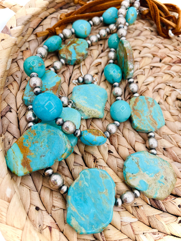 Beaded two strand necklace featuring Kingman turquoise and sterling silver beads and finished with  deer lace and slide bead. Including matching earrings. Available only from Rockstar Cowgirl online or in store in Cody, Wyoming.