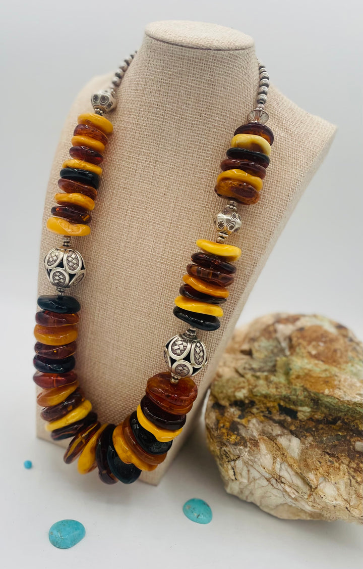 Beaded necklace featuring multi colored Baltic amber discs an handmade sterling silver beads. Available only from Rockstar Cowgirl online or in store in Cody, Wyoming.