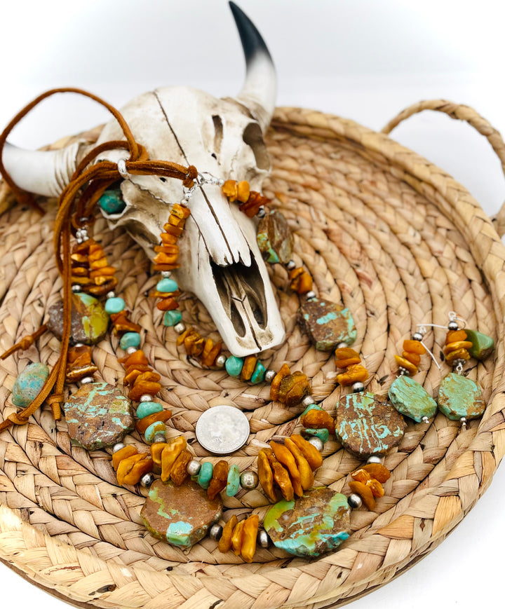 Beaded three strand necklace featuring Kingman turquoise, butterscotch amber, sterling silver beads, deer lace, and slide bead. Includes matching earrings. U.S. quarter for size reference. Available only from Rockstar Cowgirl online or in store in Cody, Wyoming.