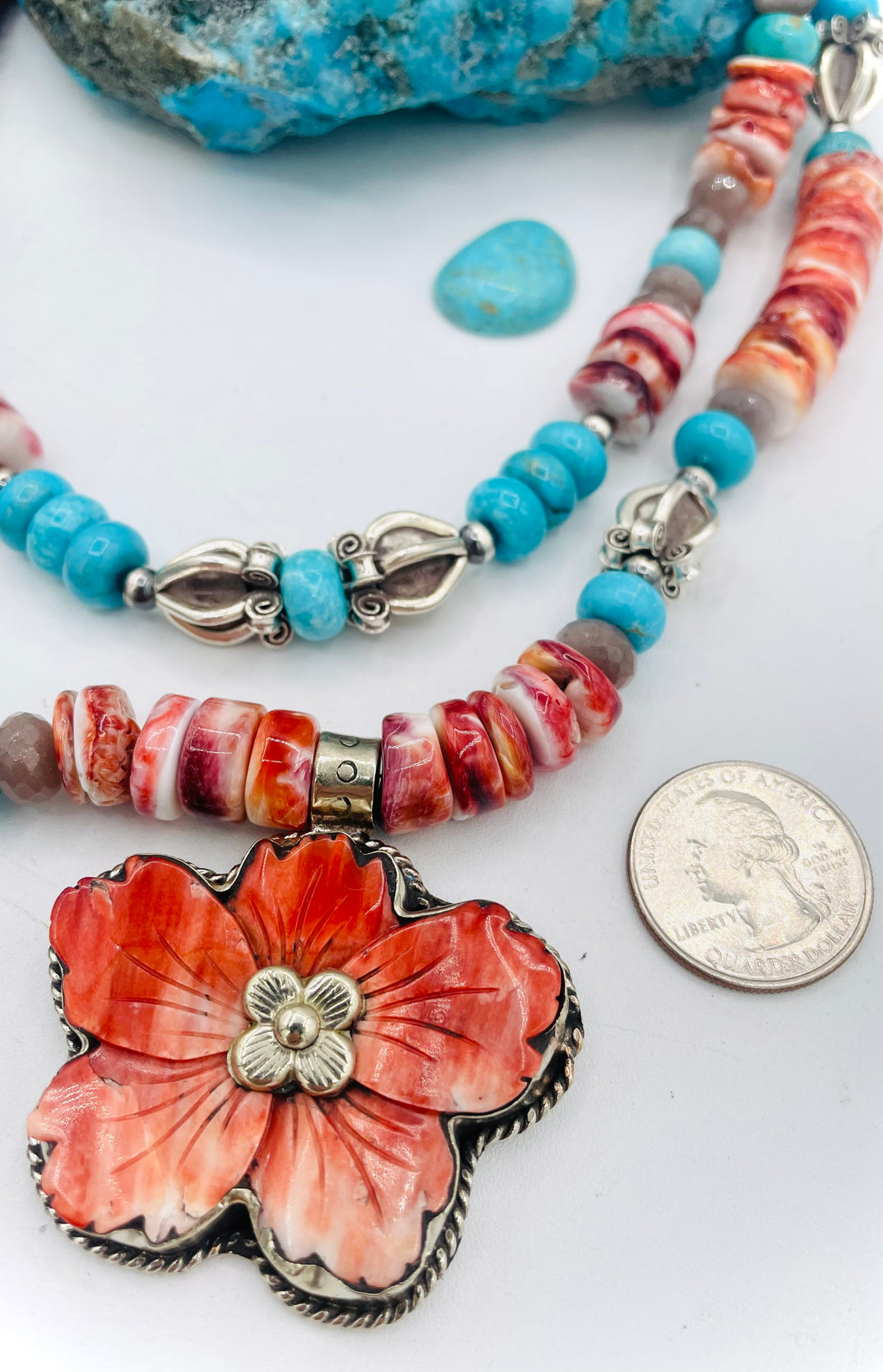 Beaded 2 strand necklace featuring spiny oyster, royal beauty turquoise, brown moonstone, and sterling silver beads with a spiny oyster flower pendent. U.S. quarter for size reference. Available only from Rockstar Cowgirl online or in store in Cody, Wyoming.