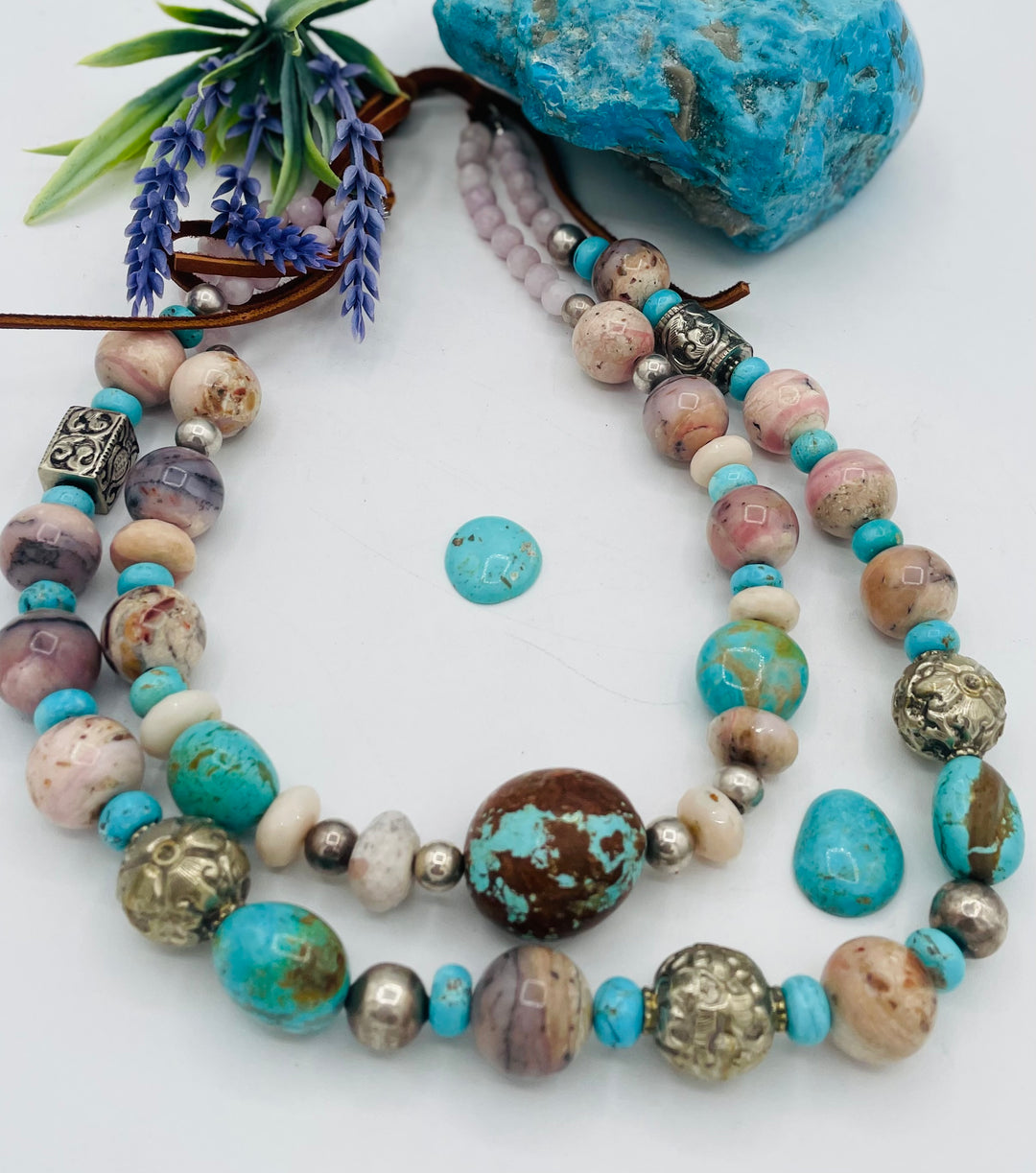 Adjustable beaded necklace featuring Pink opal, Royal beauty turquoise, Serling silver beads, Kingman turquoise, Repousse beads, pink morganite, number 8 turquoise nuggets, and finished with deer leather lace. Available only from Rockstar Cowgirl online or in store in Cody, Wyoming.